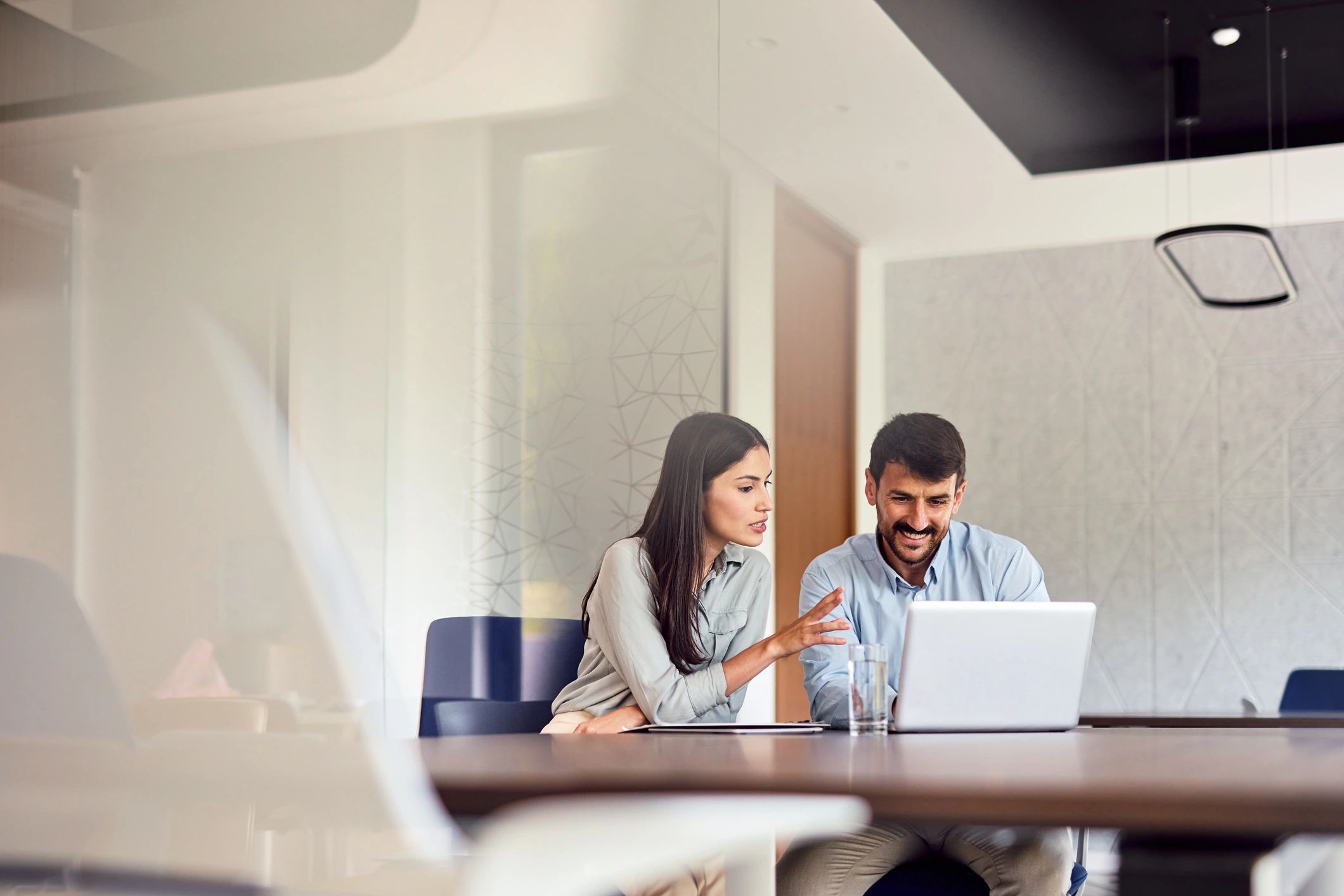 Consultants collaborating on IT planning with a laptop